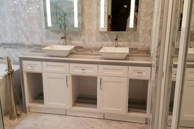 Bathroom - large modern master marble floor bathroom idea in San Diego with shaker cabinets, white cabinets, beige walls and a vessel sink