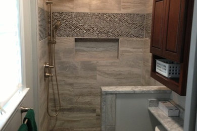 Small transitional 3/4 gray tile, white tile and porcelain tile porcelain tile doorless shower photo in Baltimore with raised-panel cabinets, dark wood cabinets, a two-piece toilet, white walls, a vessel sink and quartzite countertops