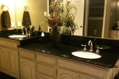Example of a bathroom design in Dallas with an undermount sink, recessed-panel cabinets, light wood cabinets and granite countertops