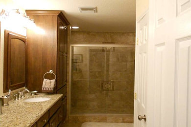 Bathroom - mid-sized traditional 3/4 beige tile and ceramic tile ceramic tile and beige floor bathroom idea in Austin with raised-panel cabinets, dark wood cabinets, beige walls, an undermount sink and granite countertops