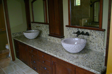 Example of a huge classic master beige tile and stone tile ceramic tile bathroom design in Sacramento with a vessel sink, medium tone wood cabinets, granite countertops, a one-piece toilet and beige walls