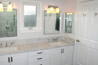 Example of a large transitional master gray tile and marble tile bathroom design in San Francisco with shaker cabinets, white cabinets, marble countertops, a one-piece toilet, white walls and an undermount sink