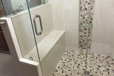 Example of a transitional master gray tile, multicolored tile and porcelain tile mosaic tile floor corner shower design in Denver with a hinged shower door