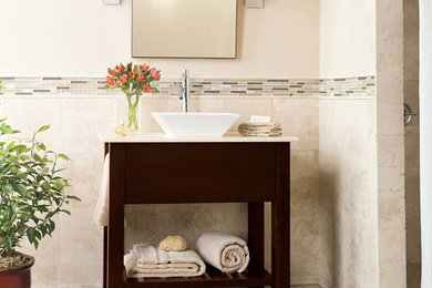 Example of a mid-sized transitional 3/4 beige tile and travertine tile travertine floor and beige floor bathroom design in San Francisco with dark wood cabinets, beige walls and a vessel sink