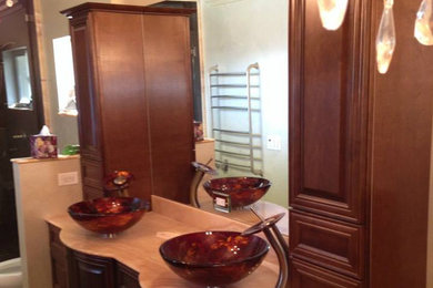 Large dark wood floor bathroom photo in Las Vegas with a vessel sink, recessed-panel cabinets, dark wood cabinets, marble countertops, a one-piece toilet and beige walls