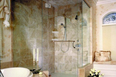 Bathroom - large traditional master beige tile, brown tile and porcelain tile travertine floor and beige floor bathroom idea in Minneapolis with a two-piece toilet, beige walls and a hinged shower door