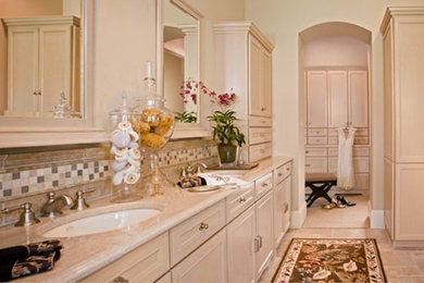 Bathroom - mid-sized contemporary master beige tile and stone tile travertine floor bathroom idea in Detroit with beaded inset cabinets, beige cabinets, marble countertops, beige walls and an undermount sink