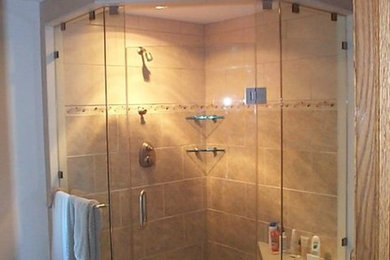 Inspiration for a mid-sized master corner shower remodel in Cleveland with white walls