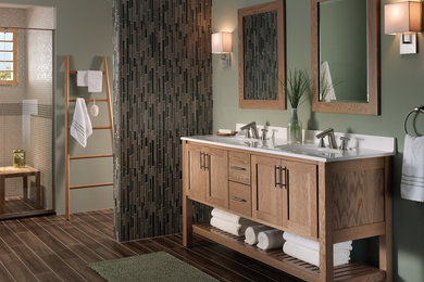 Inspiration for a medium sized traditional ensuite bathroom in Denver with freestanding cabinets, light wood cabinets, an alcove shower, multi-coloured tiles, matchstick tiles, green walls, porcelain flooring, an integrated sink, solid surface worktops and brown floors.