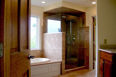 Bathroom - large transitional master stone tile travertine floor bathroom idea in Boston with raised-panel cabinets, dark wood cabinets and yellow walls