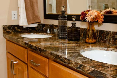 Mid-sized elegant bathroom photo in Salt Lake City with raised-panel cabinets, medium tone wood cabinets, beige walls, an undermount sink and granite countertops