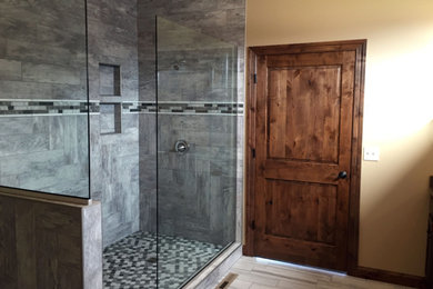 Mid-sized elegant 3/4 gray tile and porcelain tile gray floor bathroom photo in Other with recessed-panel cabinets, dark wood cabinets, beige walls, an undermount sink and granite countertops