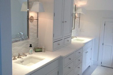Example of a mid-sized trendy master white tile and ceramic tile marble floor bathroom design in Boston with recessed-panel cabinets, white cabinets, white walls, an undermount sink and marble countertops