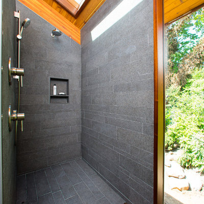 Example of a mid-sized trendy master gray tile and porcelain tile porcelain tile and gray floor bathroom design in DC Metro with gray walls, solid surface countertops, flat-panel cabinets, medium tone wood cabinets and an undermount sink