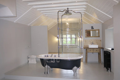 Design ideas for a large classic ensuite bathroom in Oxfordshire with a freestanding bath, a shower/bath combination, a one-piece toilet, white walls, painted wood flooring, a trough sink and white floors.
