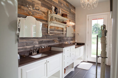 Design ideas for a large farmhouse ensuite bathroom in Oklahoma City with raised-panel cabinets, white cabinets, an alcove shower, white tiles, metro tiles, beige walls, porcelain flooring, a submerged sink, wooden worktops, black floors and an open shower.