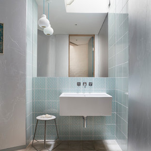 Inspiration for a medium sized contemporary shower room bathroom in London with porcelain flooring, a wall-mounted sink, grey floors, blue tiles and glass tiles.