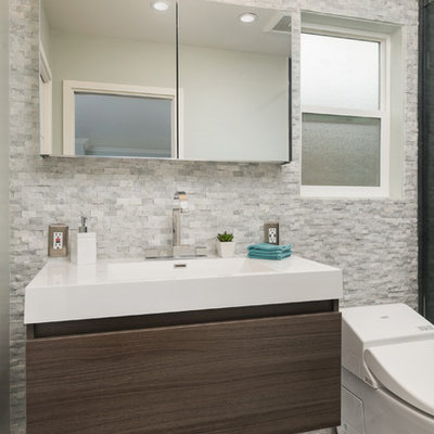 Small minimalist master cement tile and white tile ceramic tile bathroom photo in San Francisco with an integrated sink, flat-panel cabinets, dark wood cabinets, quartz countertops, a wall-mount toilet and gray walls