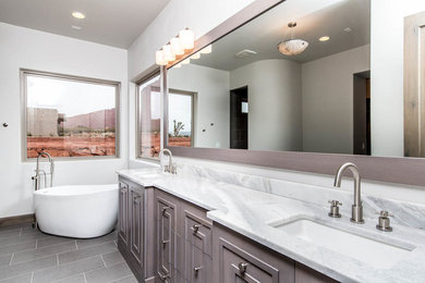 Inspiration for a mid-sized transitional master gray tile and subway tile ceramic tile and gray floor bathroom remodel in Las Vegas with furniture-like cabinets, gray cabinets, white walls, an undermount sink and limestone countertops