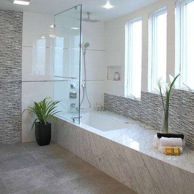 Example of a trendy gray tile and matchstick tile tub/shower combo design in San Francisco with an undermount tub