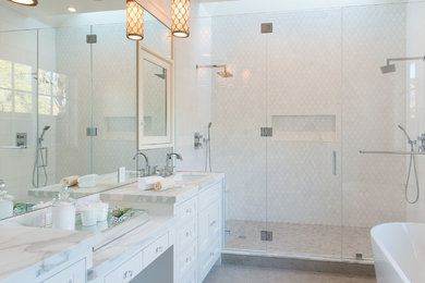 Large transitional master gray tile and stone tile limestone floor bathroom photo in San Francisco with an undermount sink, shaker cabinets, white cabinets, marble countertops, a one-piece toilet, white walls and a hinged shower door