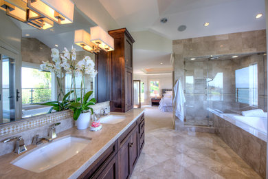 Bathroom - large traditional beige tile and travertine tile travertine floor, beige floor, double-sink, wood ceiling and wood wall bathroom idea in San Francisco with shaker cabinets, brown cabinets, a one-piece toilet, beige walls, an undermount sink and a built-in vanity