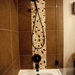 Photo of a mid-sized country 3/4 bathroom in Salt Lake City with shaker cabinets, orange cabinets, a drop-in tub, a shower/bathtub combo, a one-piece toilet, brown tile, ceramic tile, beige walls, porcelain floors, a drop-in sink and granite benchtops.