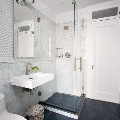 Corner shower - small contemporary gray tile and mosaic tile porcelain tile, black floor and single-sink corner shower idea in New York with a one-piece toilet, white walls, a wall-mount sink and a hinged shower door