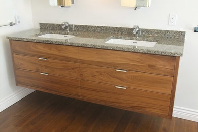 Large minimalist master dark wood floor bathroom photo in Vancouver with an undermount sink, flat-panel cabinets, medium tone wood cabinets, granite countertops, a one-piece toilet and white walls