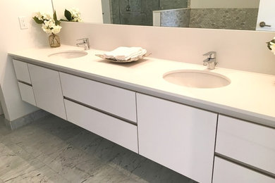 Example of a large trendy master bathroom design in Toronto with flat-panel cabinets, white cabinets and quartz countertops