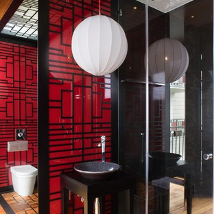 Photo of an asian bathroom in Other with a vessel sink and red walls.