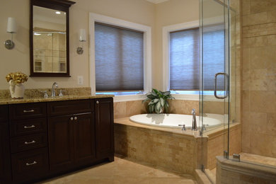 Mid-sized elegant master brown tile and ceramic tile ceramic tile and brown floor bathroom photo in Baltimore with raised-panel cabinets, dark wood cabinets, beige walls, granite countertops and a hinged shower door