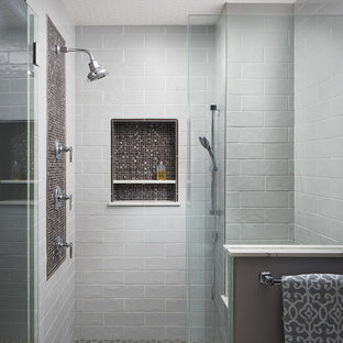 Photo of a large transitional master bathroom in Other with flat-panel cabinets, medium wood cabinets, a freestanding tub, a double shower, a two-piece toilet, gray tile, ceramic tile, grey walls, porcelain floors, an undermount sink, marble benchtops, grey floor, a hinged shower door and red benchtops.
