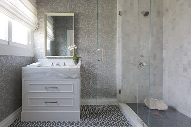 Corner shower - mid-sized traditional 3/4 mosaic tile floor corner shower idea in Los Angeles with recessed-panel cabinets, white cabinets, gray walls, an integrated sink and a hinged shower door