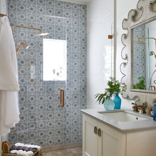 Idéer för att renovera ett mellanstort shabby chic-inspirerat badrum med dusch, med skåp i shakerstil, gula skåp, en dusch i en alkov, blå kakel, vit kakel, cementkakel, vita väggar, klinkergolv i keramik, ett undermonterad handfat, bänkskiva i akrylsten, beiget golv och dusch med gångjärnsdörr