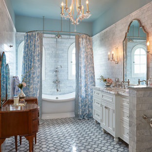 Example of a classic gray tile and marble tile multicolored floor bathroom design in Los Angeles with furniture-like cabinets, white cabinets, blue walls, an undermount sink and gray countertops