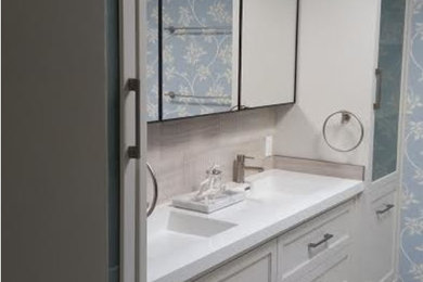 Mid-sized trendy master gray floor bathroom photo in Los Angeles with shaker cabinets, white cabinets, blue walls, an integrated sink, quartz countertops and white countertops
