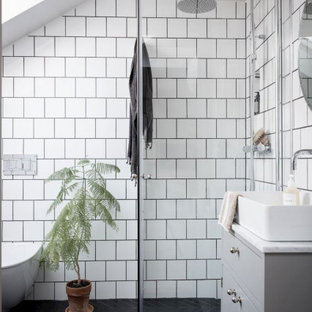 Inspiration for a contemporary bathroom in Sydney with flat-panel cabinets, grey cabinets, a curbless shower, a vessel sink, black floor, a hinged shower door, white benchtops, a single vanity and a freestanding vanity.