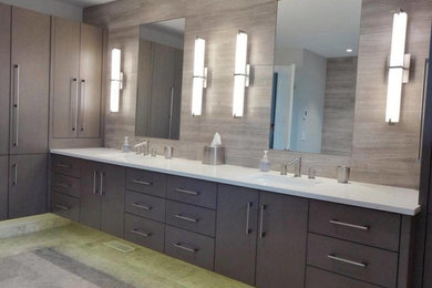 Inspiration for a large contemporary master gray tile and ceramic tile ceramic tile and gray floor bathroom remodel in Chicago with flat-panel cabinets, gray cabinets, gray walls, an undermount sink and solid surface countertops