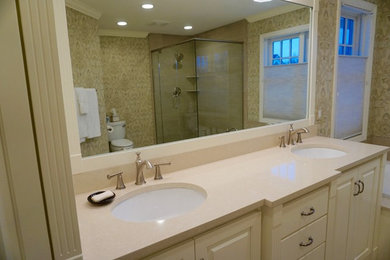 Example of a large trendy master gray tile and ceramic tile porcelain tile bathroom design in Minneapolis with raised-panel cabinets, white cabinets, a two-piece toilet, multicolored walls, an undermount sink and quartz countertops