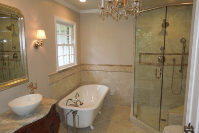 Small transitional master beige tile and porcelain tile porcelain tile and beige floor bathroom photo in Atlanta with furniture-like cabinets, dark wood cabinets, a two-piece toilet, beige walls, a vessel sink, marble countertops and a hinged shower door