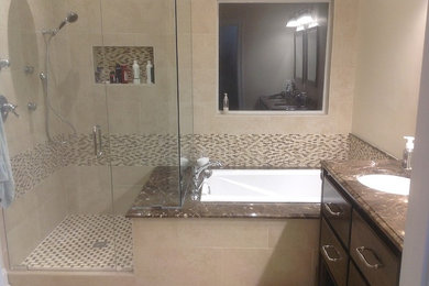 Bathroom - mid-sized transitional master beige tile and ceramic tile ceramic tile and beige floor bathroom idea in Jackson with an undermount sink, furniture-like cabinets, dark wood cabinets, marble countertops, a two-piece toilet, beige walls and a hinged shower door