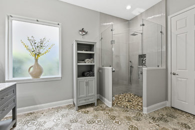 Inspiration for a mid-sized contemporary master gray tile and porcelain tile porcelain tile and multicolored floor corner shower remodel in Jacksonville with shaker cabinets, gray cabinets, a two-piece toilet, gray walls, an integrated sink, quartz countertops, a hinged shower door and white countertops