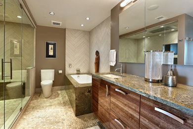 Alcove shower - mid-sized contemporary master white tile and porcelain tile pebble tile floor alcove shower idea in Denver with an undermount sink, flat-panel cabinets, medium tone wood cabinets, a two-piece toilet, granite countertops, brown walls and an undermount tub