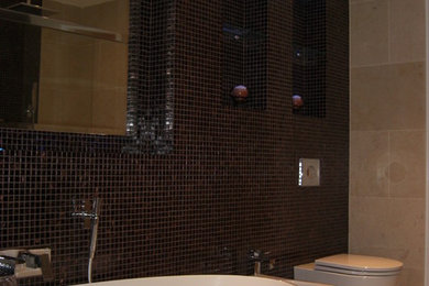 This is an example of a large traditional ensuite bathroom in Other with an integrated sink, a freestanding bath, a double shower, a wall mounted toilet, beige tiles, stone tiles, beige walls and marble flooring.
