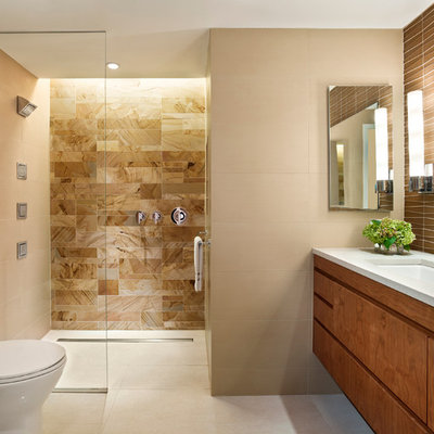 Example of a trendy beige tile and stone tile porcelain tile and beige floor walk-in shower design in Philadelphia with an undermount sink, flat-panel cabinets, medium tone wood cabinets, beige walls and white countertops