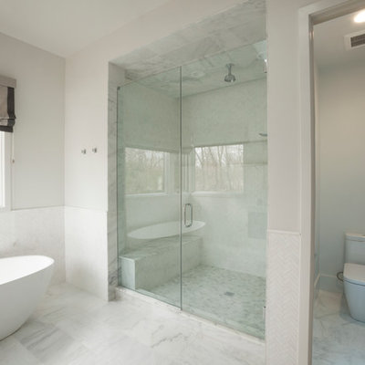 Example of a mid-sized trendy master white tile and porcelain tile porcelain tile and white floor bathroom design in New York with flat-panel cabinets, blue cabinets, a one-piece toilet, white walls, an integrated sink, solid surface countertops and a hinged shower door