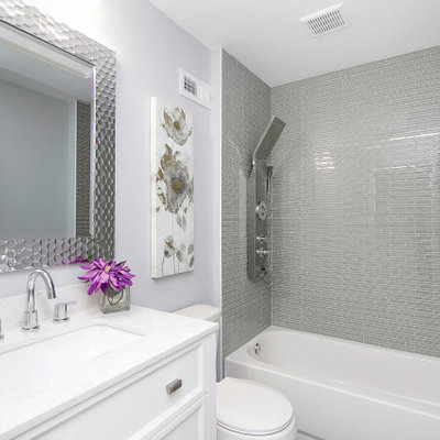 Small trendy 3/4 gray tile and matchstick tile bathroom photo in Philadelphia with shaker cabinets, white cabinets, a two-piece toilet, purple walls, an undermount sink, white countertops and granite countertops