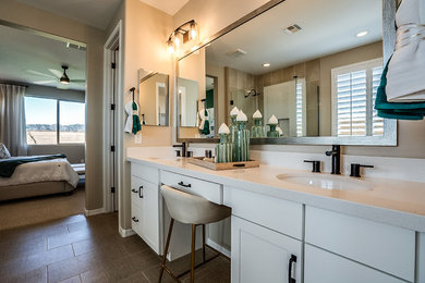 Bathroom - mid-sized contemporary master beige tile and ceramic tile ceramic tile and brown floor bathroom idea in Phoenix with recessed-panel cabinets, white cabinets, beige walls, an undermount sink, solid surface countertops, a hinged shower door and beige countertops