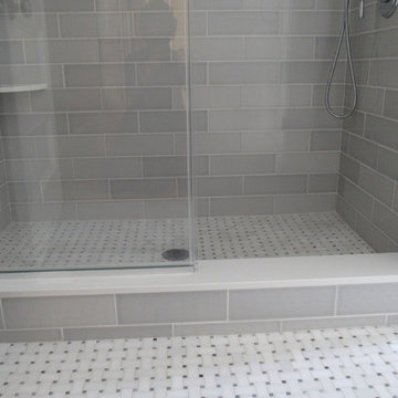 Photo detail of shower curb and flooring material.